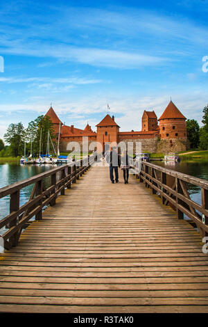 Lithuania, Vilnius. Wooden footbridge leads to Trakai Castle Stock Photo