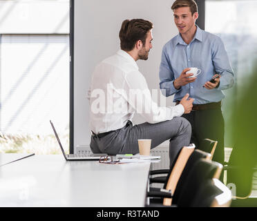 Two colleagues working on project in office together Stock Photo