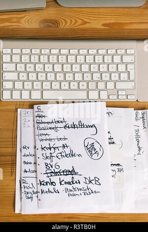To-do list next to computer keyboard Stock Photo