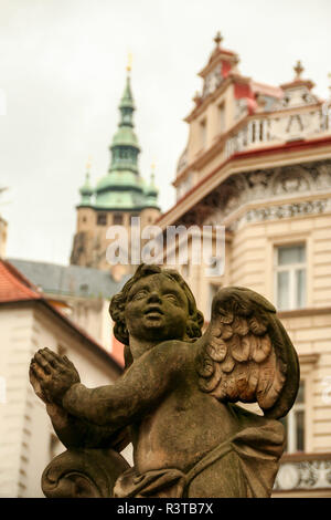 an angel on the The Holiest Trinity column  in the upper part of the Lesser Town Square, Mala Strana in Prague Czech Republic Stock Photo