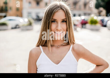 Portrait of smiling teenage girl in the city Stock Photo