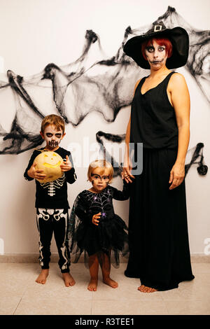 Mother and her two children dressed up for Halloween Stock Photo