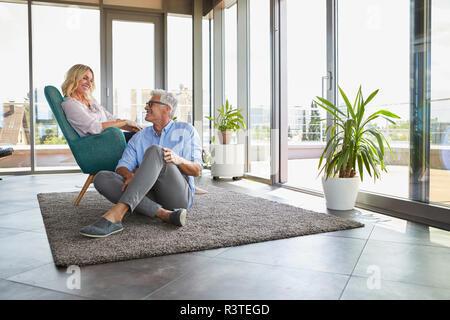 Smiling mature couple relaxing at home Stock Photo