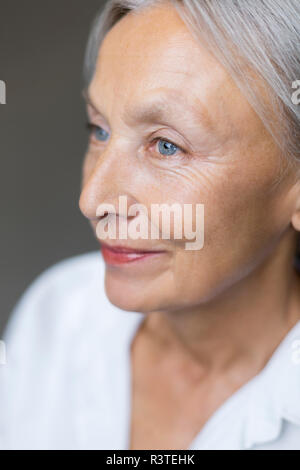 Half profile of blue eyed senior woman Stock Photo