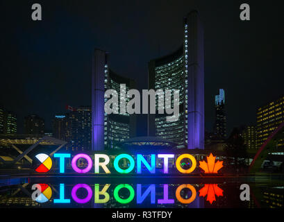 A night view of the 3D TORONTO sign, Toronto City Hall (New City Hall), and Nathan Phillips Square in downtown Toronto, Ontario, Canada. Stock Photo