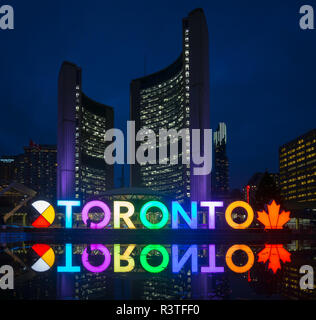 A night view of the 3D TORONTO sign, Toronto City Hall (New City Hall), and Nathan Phillips Square in downtown Toronto, Ontario, Canada. Stock Photo