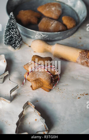 Stack of star-shaped Christmas Cookies and cookie cutters Stock Photo