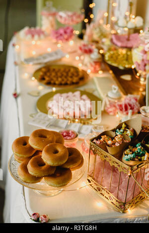 Candy bar beautifully decorated with sweets in a vintage event. Stock Photo