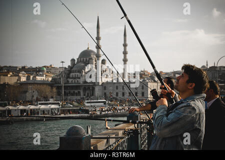 Istanbul, Turkey - April 5, 2012: Turkish citizens fishing with their rods on the Bosphorus bridges. Stock Photo