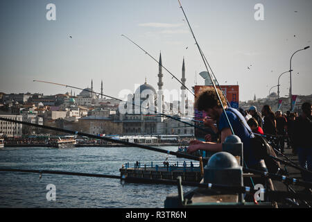 Istanbul, Turkey - April 5, 2012: Turkish citizens fishing with their rods on the Bosphorus bridges. Stock Photo