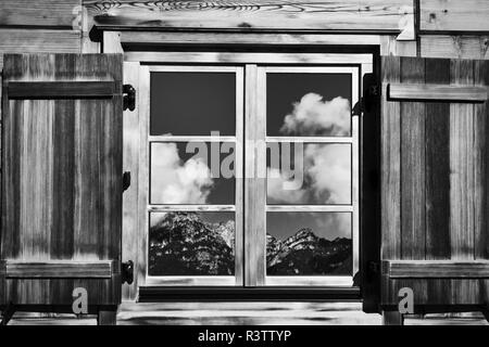 cottage window with mountain views in black and white Stock Photo