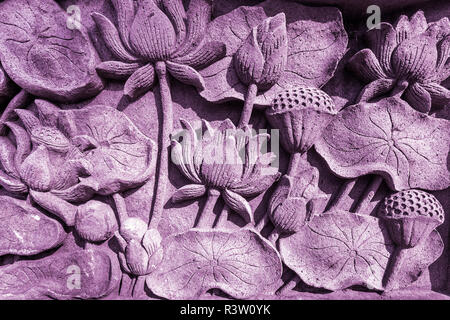 Lotus Flower stone sculpture textured and magenta pink color wall. Stock Photo