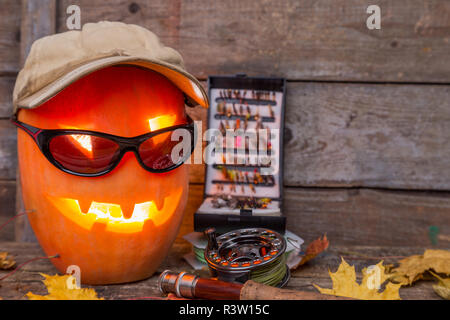halloween pumpkin in hat with fly-fishing tackles Stock Photo - Alamy