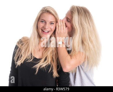 two blond young girls whisper together Stock Photo