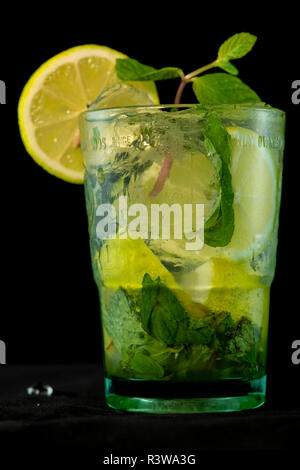 Mojito Cocktail with rum, brown sugar, lemon juice, mint and soda water with isolated black background Stock Photo