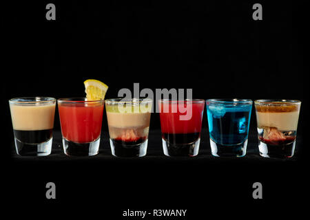 Various alcoholic cocktail shots together with isolated black background Stock Photo
