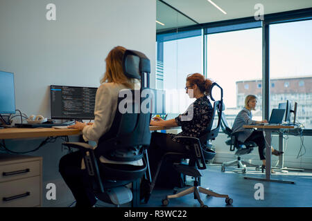 Businesswomen using computers in office Stock Photo