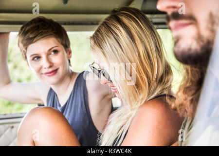 Smiling friends in a van Stock Photo