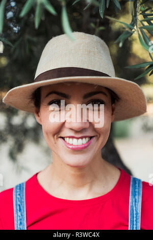 Portrait of smiling woman wearing hat Stock Photo