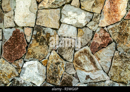 Color background of raw natural stone, for the facade of the house in gray and brown shades Stock Photo