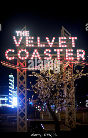 Illuminated Velvet Coaster pub sign and Pleasure Beach casino tower at night,Blackpool,UK Stock Photo