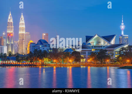 KUALA LUMPUR, MALAYSIA - JULY 25: This is a night view of the Kuala Lumpur Skyline and Istana Budaya tradtional theatre, taken from Titiwangsa park Ju Stock Photo