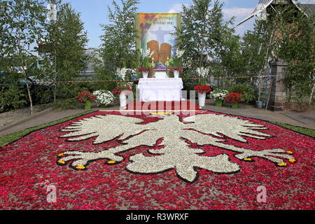 Big Polish emblem made of petal on ground in front of altar to celebrate annual Corpus Christi procession in Spycimierz, village in Poland. Stock Photo