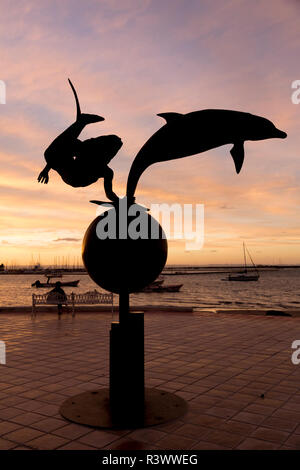 Mexico, Baja California Sur, La Paz. Statues on the Malecon seaside promenade. Sunset. Stock Photo
