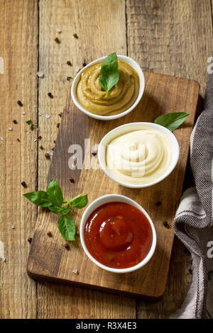 https://l450v.alamy.com/450v/r3x4e3/set-of-sauces-ketchup-mayonnaise-and-mustard-sauce-on-a-wooden-table-copy-space-r3x4e3.jpg