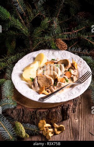 potatoes with pork medallions and chanterelle sauce Stock Photo