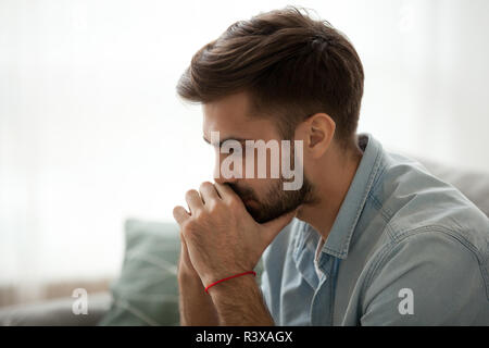 Serious millennial man thinking of problem solution Stock Photo