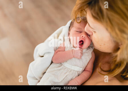 Newborn baby yawning. Stock Photo