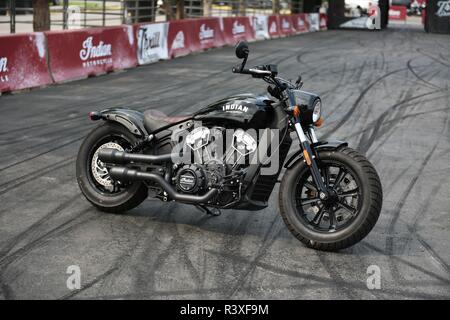 American made Indian Scout motorcycle on an exhibition track with a background of rubber tire burnout marks. Stock Photo