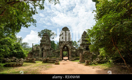 Entrance of a temple complex. Angkor, Cambodia.Banteay Srei : the temple consists of low walls that surround peak structures of deep red sandstone. Stock Photo