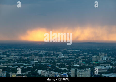 Almaty Skyline during a Sunset Rain, Kazakhstan in August 2018 taken in hdr Stock Photo