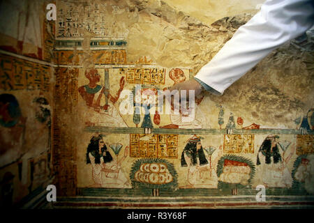 Luxor, Egypt. 24th Nov, 2018. An archeologist points at a mural inside a tomb unearthed by an Egyptian archeological mission working at al-Asassif area on the West Bank of Luxor, Egypt, on Nov. 24, 2018. Egyptian Ministry of Antiquities announced on Saturday the discovery of an ancient tomb in Luxor province in Upper Egypt. Credit: Ahmed Gomaa) (wh/Xinhua/Alamy Live News Stock Photo