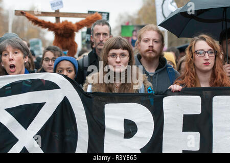 Environmental activists seen holding a banner during the protest.   Thousands of demonstrators from the new Extinction Rebellion climate change movement gathered at Parliament Square for a memorial and funeral march through London. Demonstrators paid homage to the lives lost due to climate change, and marched carrying a coffin from Parliament Square to Buckingham Palace. Stock Photo