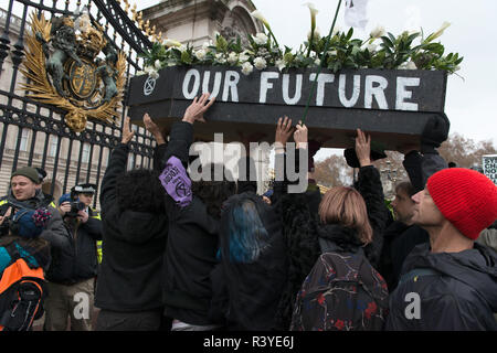 Activists seen carrying a coffin during the march.  Thousands of demonstrators from the new Extinction Rebellion climate change movement gathered at Parliament Square for a memorial and funeral march through London. Demonstrators paid homage to the lives lost due to climate change, and marched carrying a coffin from Parliament Square to Buckingham Palace. Stock Photo