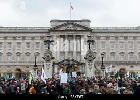 Climate change activist stand outside the gates of Buckingham Palace.  Thousands of demonstrators from the new Extinction Rebellion climate change movement gathered at Parliament Square for a memorial and funeral march through London. Demonstrators paid homage to the lives lost due to climate change, and marched carrying a coffin from Parliament Square to Buckingham Palace. Stock Photo