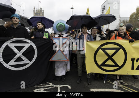 London, Greater London, UK. 24th Nov, 2018. Demonstrators carrying banners during the march.Thousands of demonstrators from the new Extinction Rebellion climate change movement gathered at Parliament Square for a memorial and funeral march through London. Demonstrators paid homage to the lives lost due to climate change, and marched carrying a coffin from Parliament Square to Buckingham Palace. Credit: Andres Pantoja/SOPA Images/ZUMA Wire/Alamy Live News Stock Photo