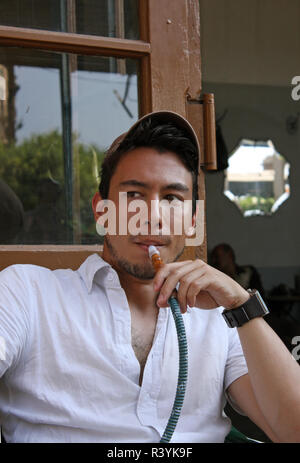 Man enjoying a hookah in a cafe in Beirut, Lebanon Stock Photo