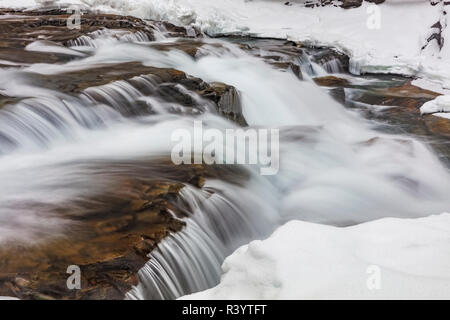 Winter along McDonald Falls in Glacier National Park, Montana, USA Stock Photo