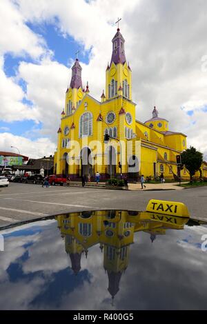 Wooden church Iglesia de San Francisco, UNESCO World Heritage Site, reflected in Taxi, Castro, Chiloé Island, Chile Stock Photo