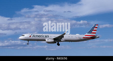 American Airlines Airbus A321 Flying under Beautiful Sky Stock Photo