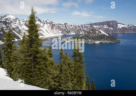 USA, Oregon, Crater Lake National Park. Snow still lines the crater rim in spring. Stock Photo
