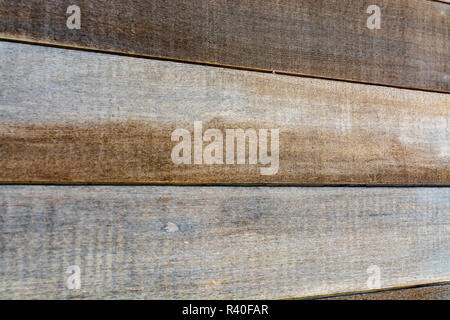 Background texture of rustic brown natural hardwood with a distinctive wood grain pattern for use a design template in a full frame landscape view Stock Photo
