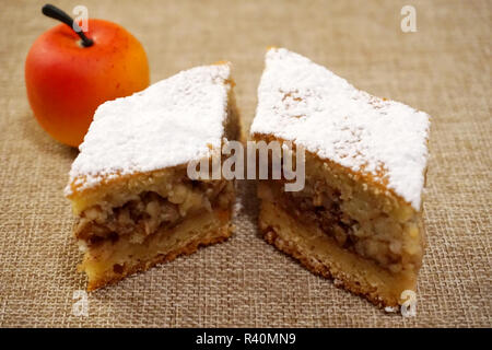 Two pieces of a juicy cinnamon apple pie sprinkled with withe sugar Stock Photo