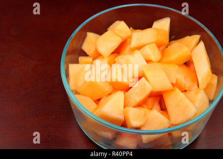 Cantaloupe Pieces in a Clear Glass Bowl on Wood Stock Photo