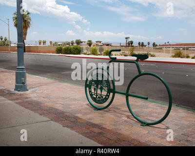 PALM SPRINGS, CA - JULY 18, 2018: A modern bike rack next to a public street in Palm Springs, California functions as both public art and a place for  Stock Photo