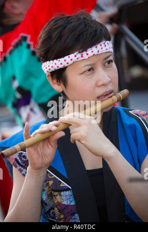 USA, Washington State, Seattle. Young woman plays Japanese flute Stock Photo